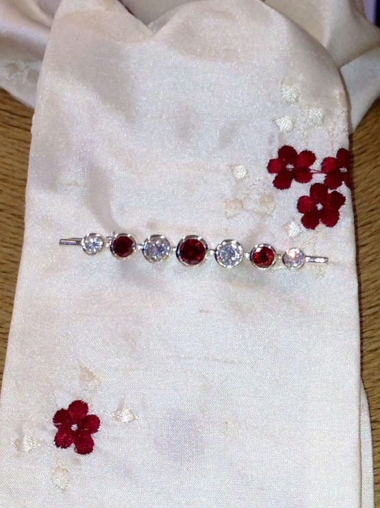 Ivory embroidered crimson cluster flower silk stock accessorised with our garnet graduated stones stock pin